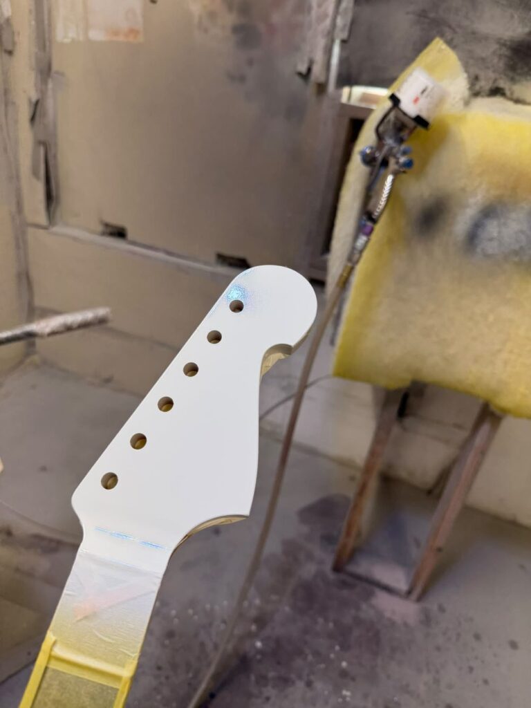 Freshly painted headstock of the handcrafted guitar